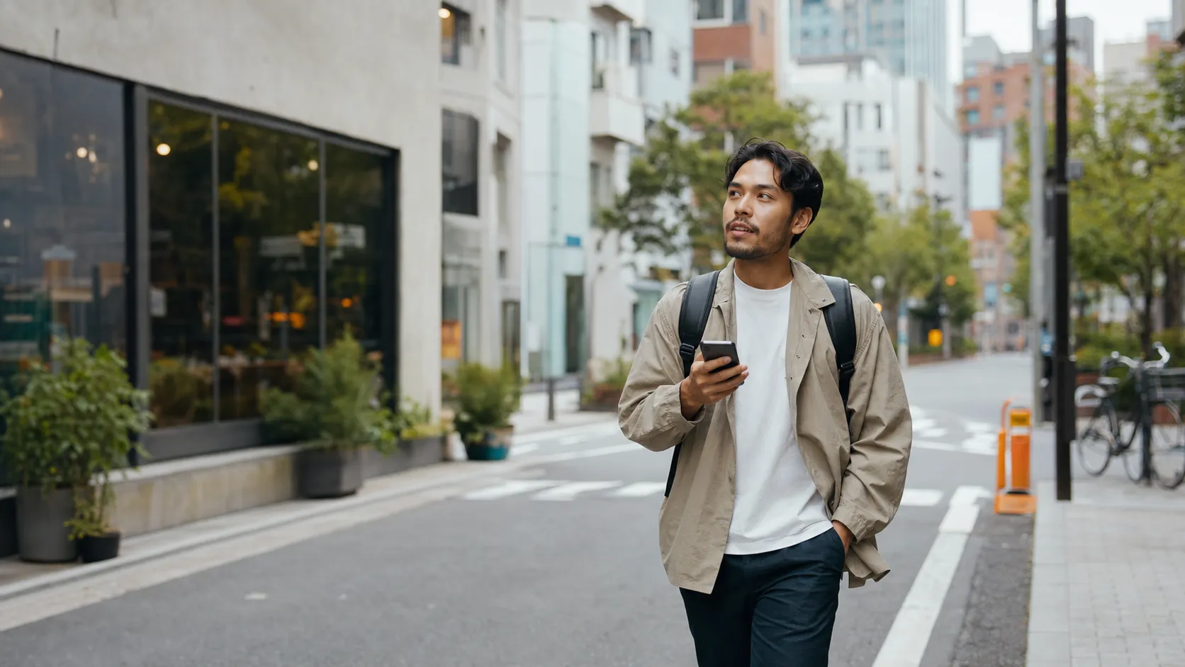A traveler using maps and translation on their phone while walking through central Tokyo